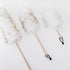 Three feather dusters on a white background
