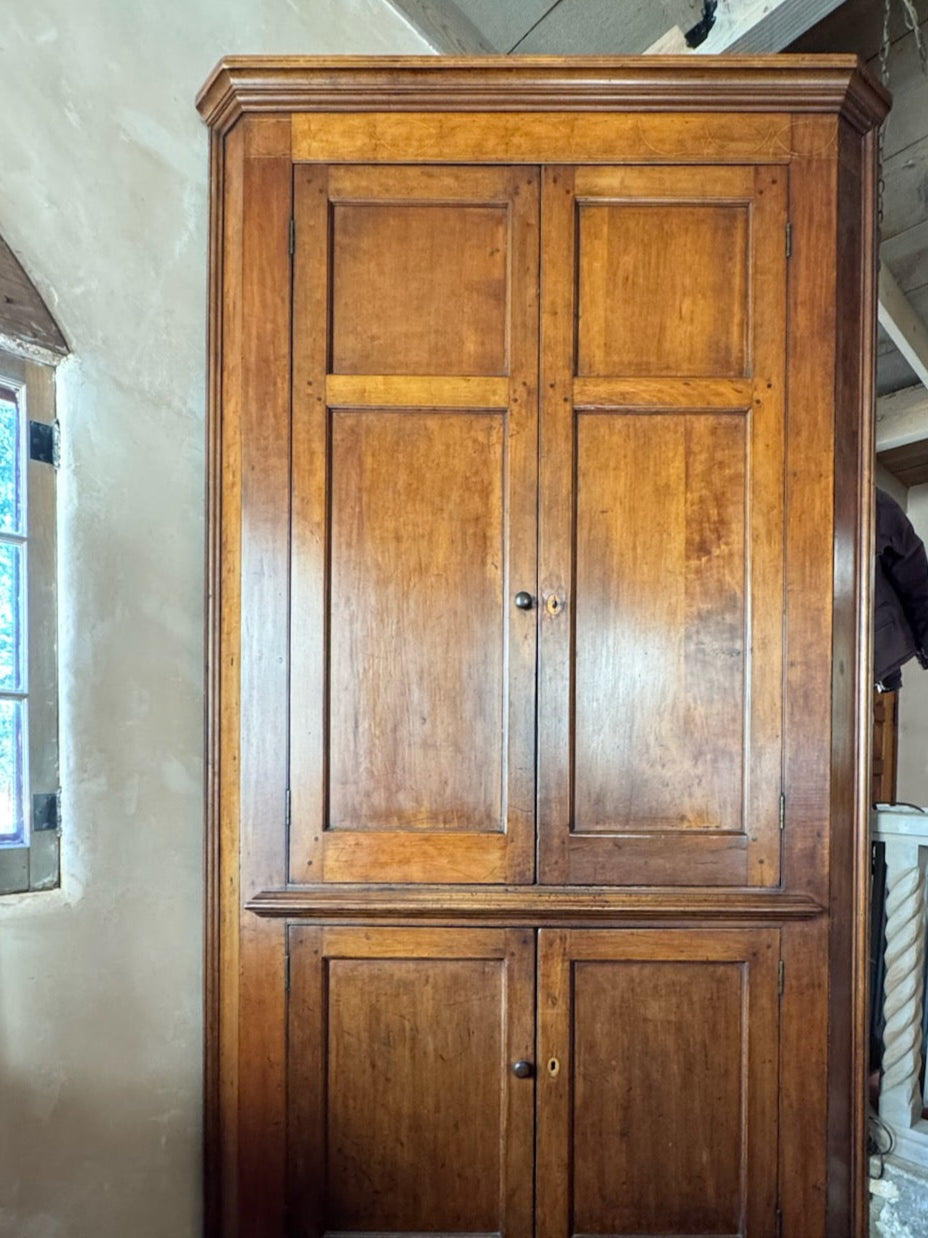 Wooden wardrobe in a room with a staircase and window